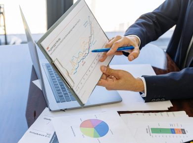 Free Business professionals discussing financial graphs and charts in an office setting. Stock Photo