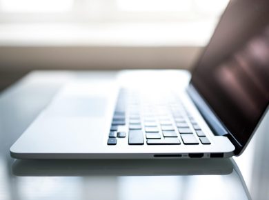 Free Elegant side view of a laptop on a glossy table with natural lighting indoors. Stock Photo