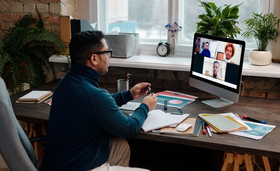 teacher-video-calling-with-his-students-using-a-computer